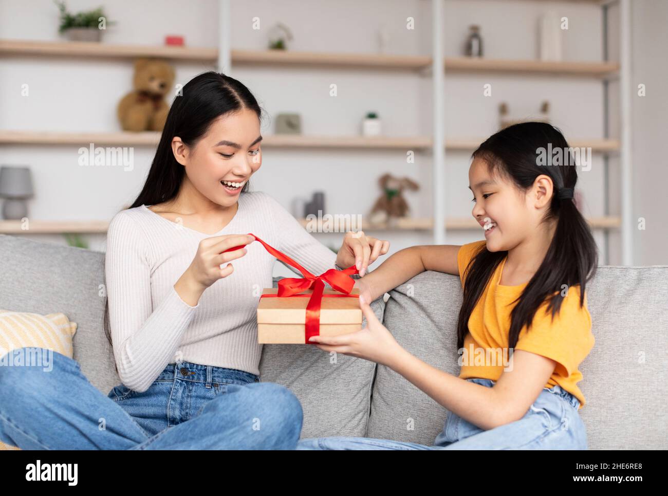 Premium Photo  Joyful asian mother and teenage daughter holding gift box