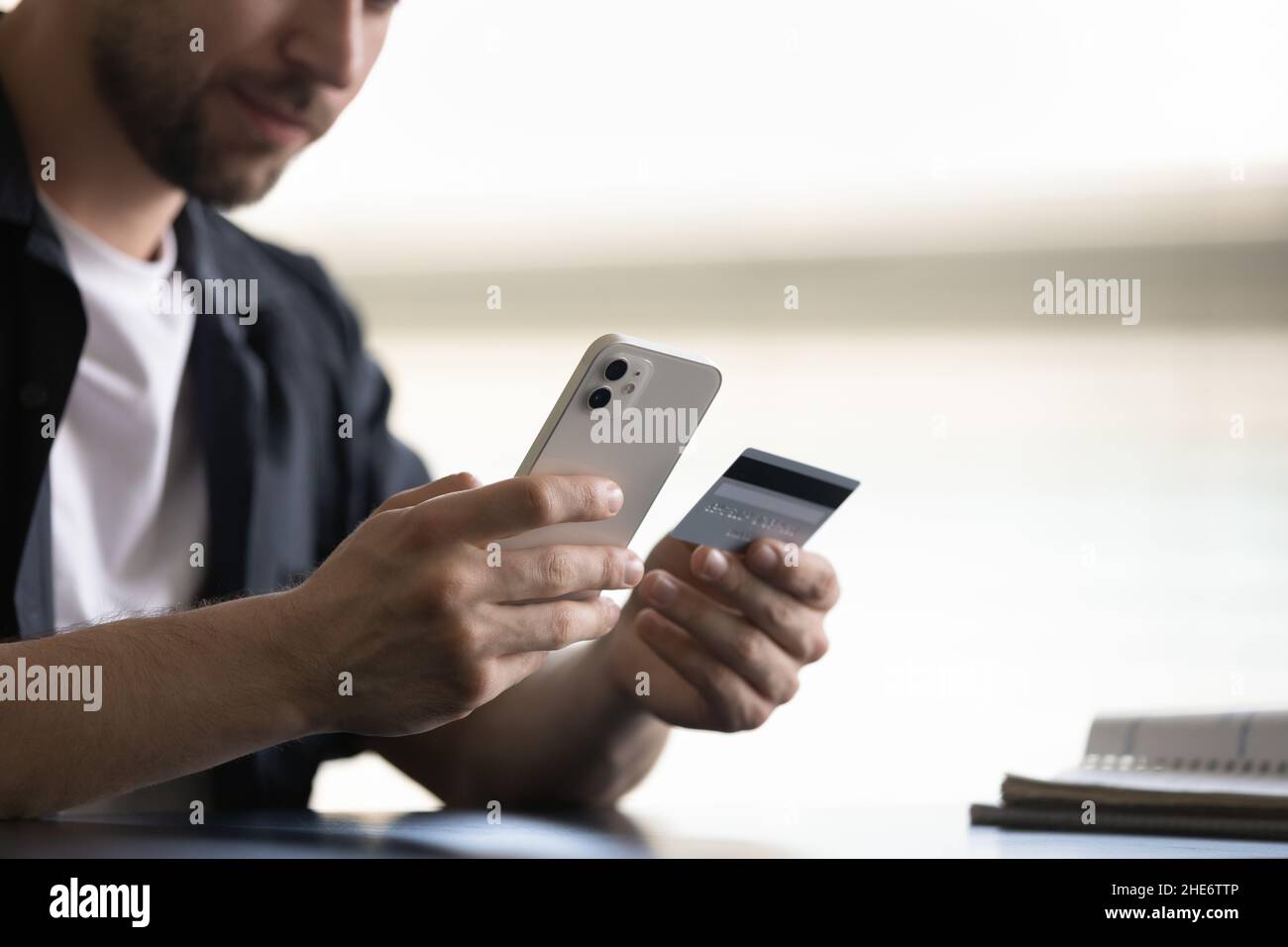 Close up happy young man shopping in mobile application. Stock Photo