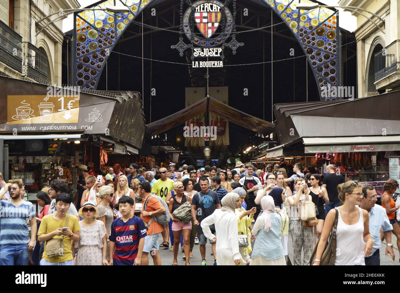 Crowd of shoppers, main entrance to La Boqueria market, covered marketplace located at La Rambla in Ciutat Vella district of Barcelona Spain. Stock Photo