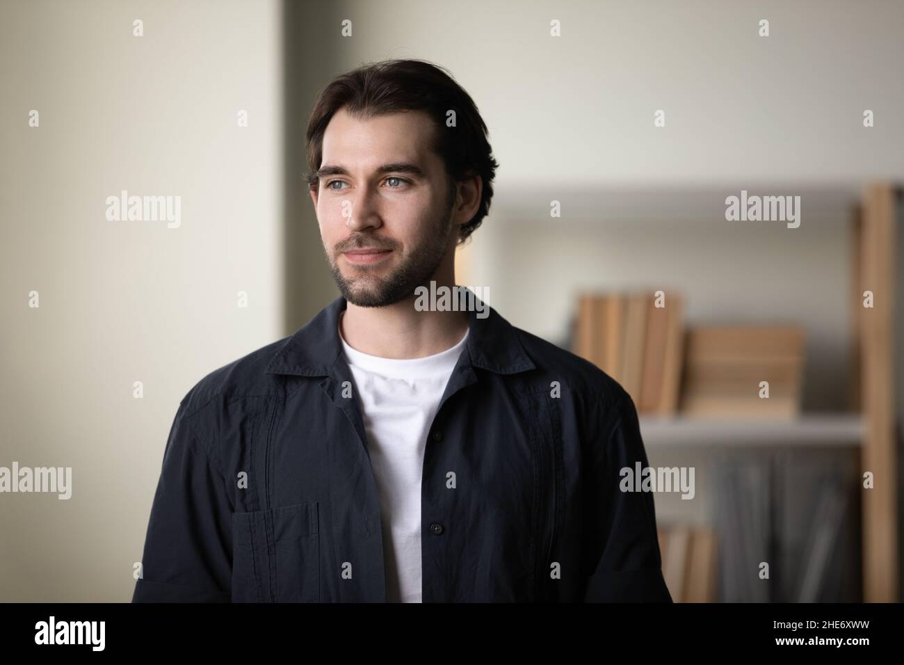 Happy dreamy young man looking in distance. Stock Photo