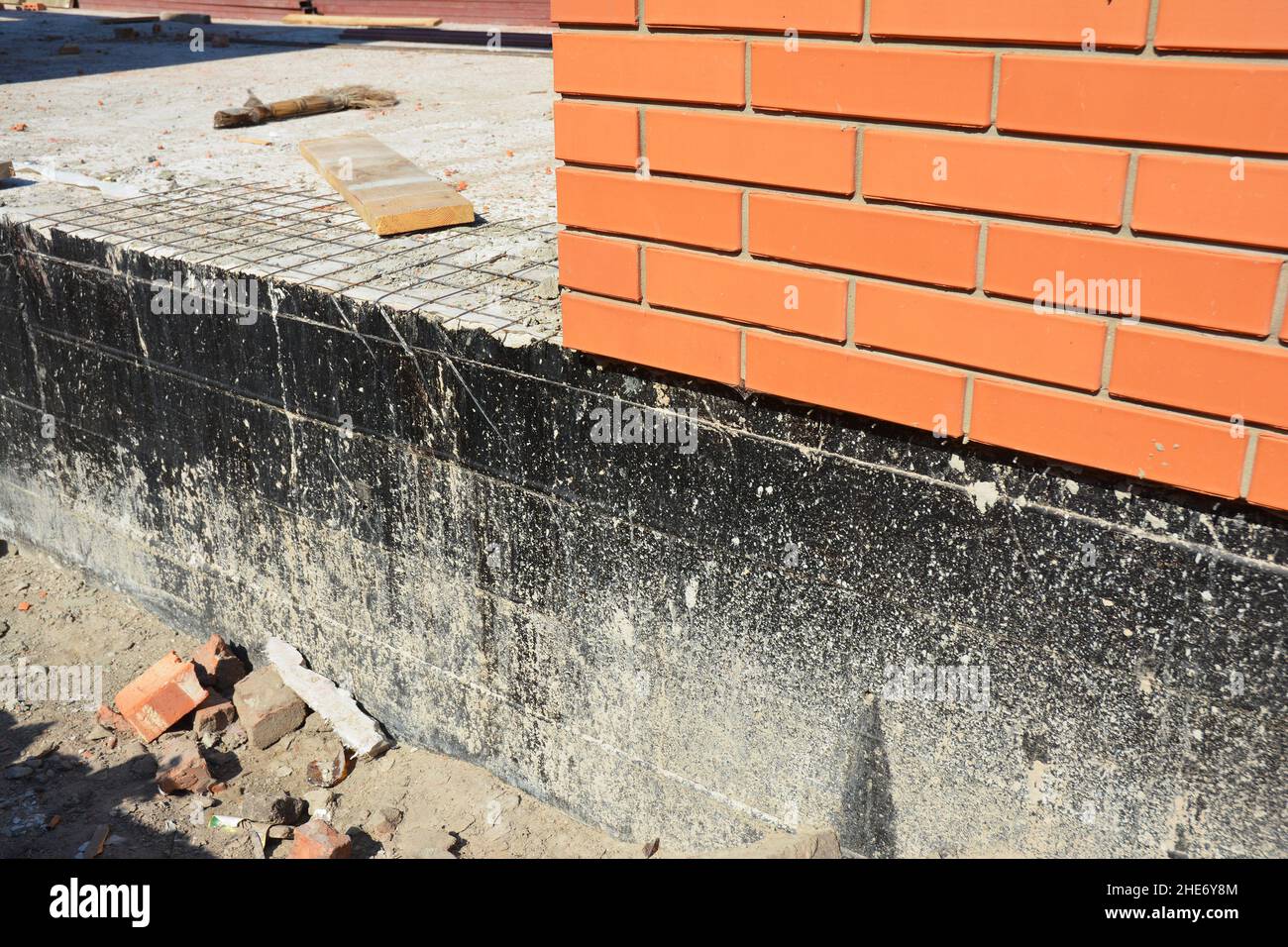 Waterproofing a new brick house foundation with spray on tar