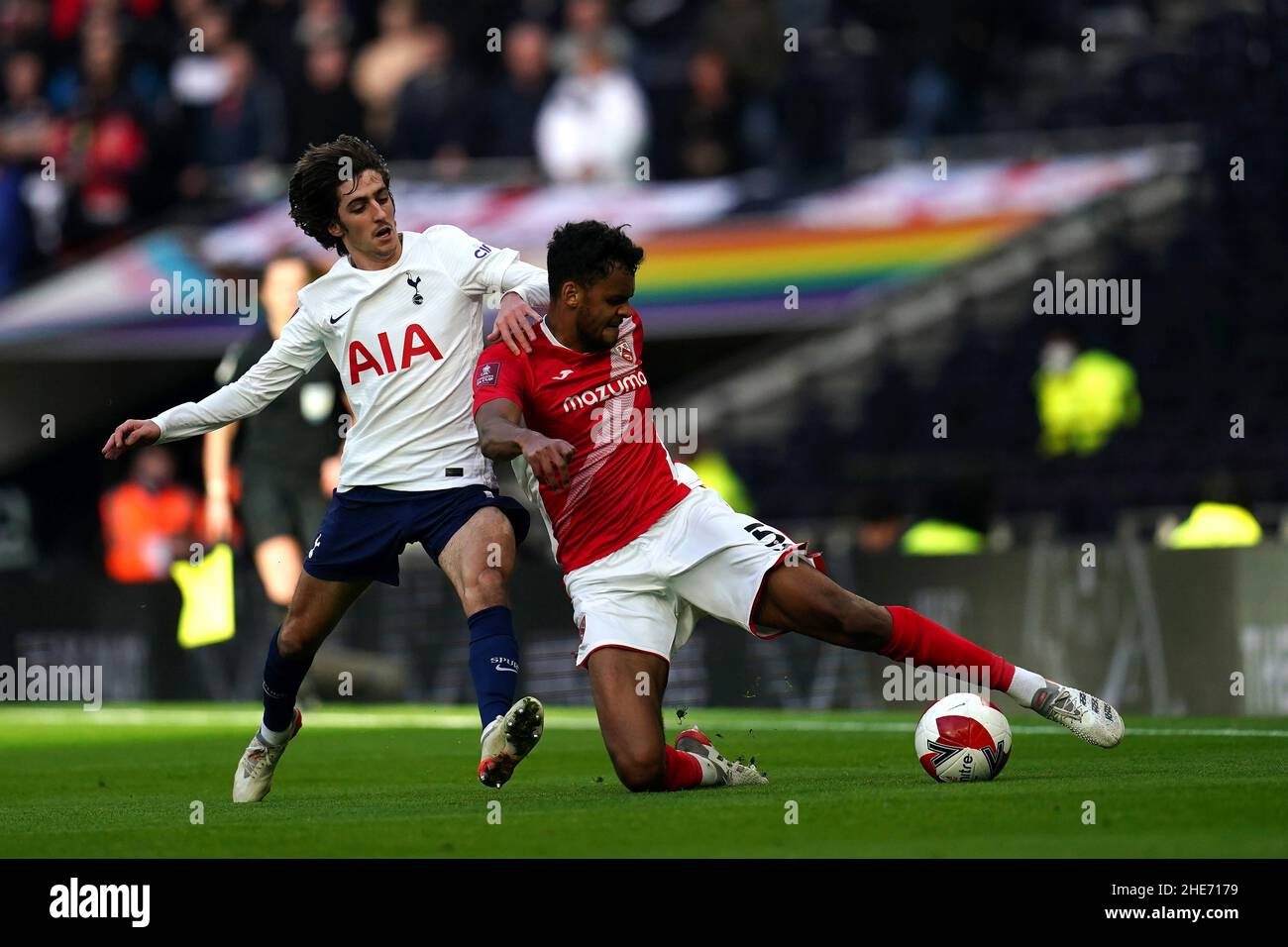 Tottenham Hotspur's Bryan Gil Salvatierra (left) and Morcambe's Jacob Bedeau battle for the ball during the Emirates FA Cup third round match at Tottenham Hotspur Stadium, London. Picture date: Sunday January 9, 2022. Stock Photo