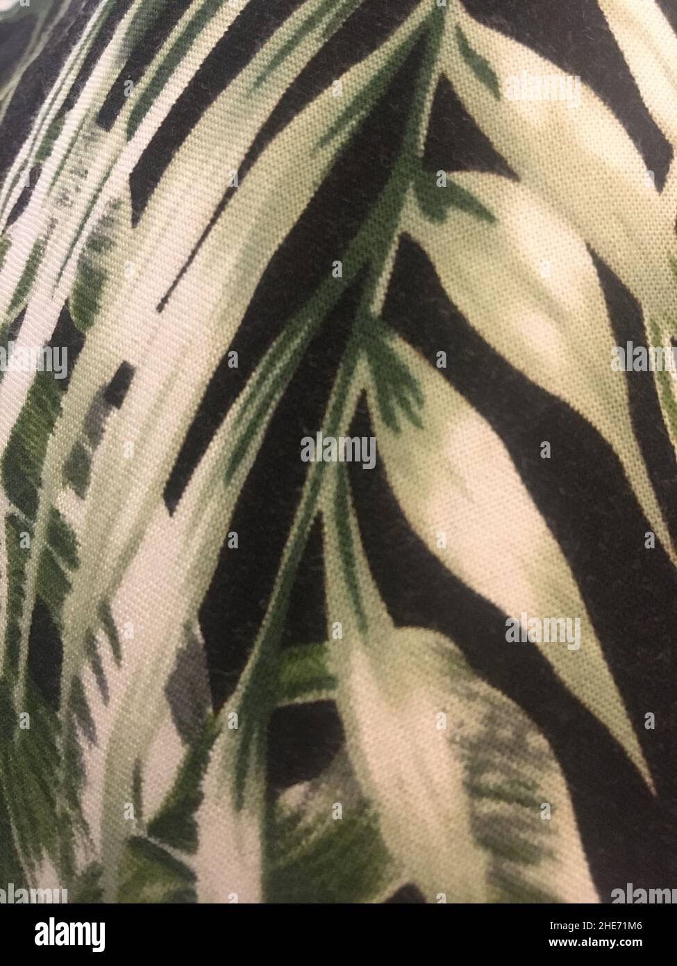 Tropical Palm Leaf Pattern On Black Fabric Texture Stock Photo
