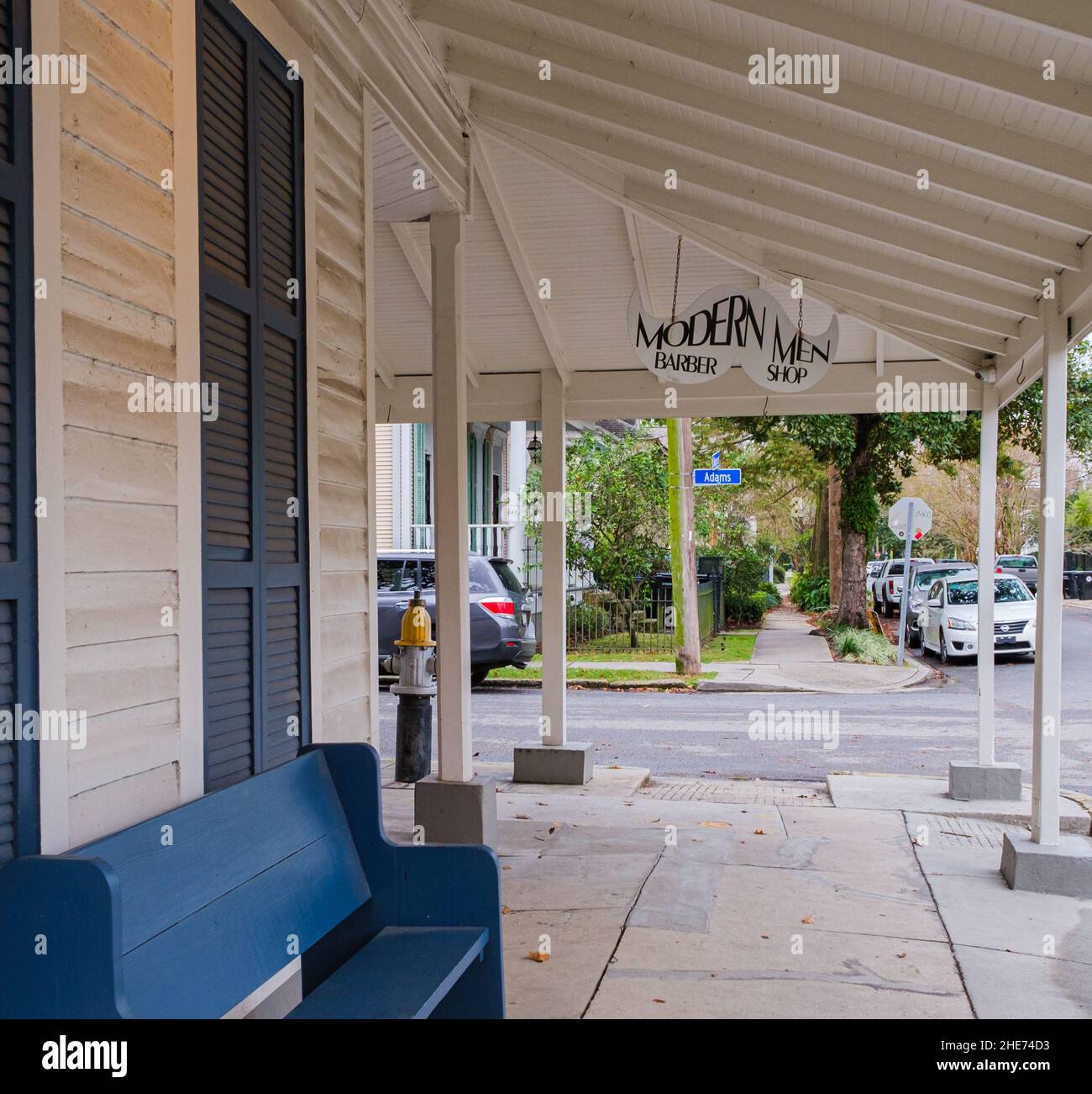 NEW ORLEANS, LA, USA - JANUARY 2, 2022: Front of Modern Men Barber Shop with sign and bench in Uptown New Orleans Stock Photo