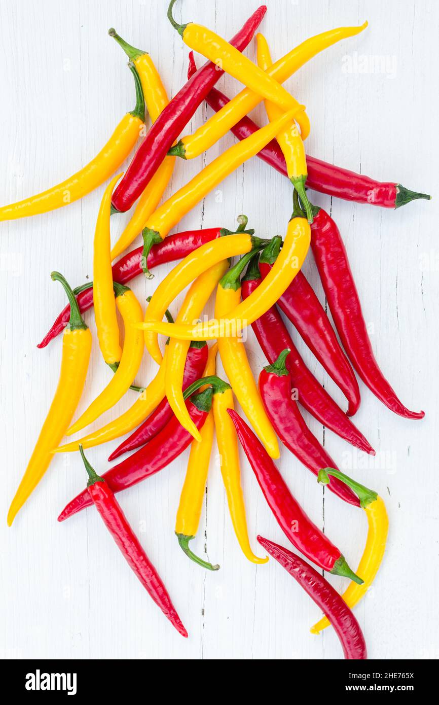 Directly above shot of Red hot chili peppers on wooden table Stock Photo