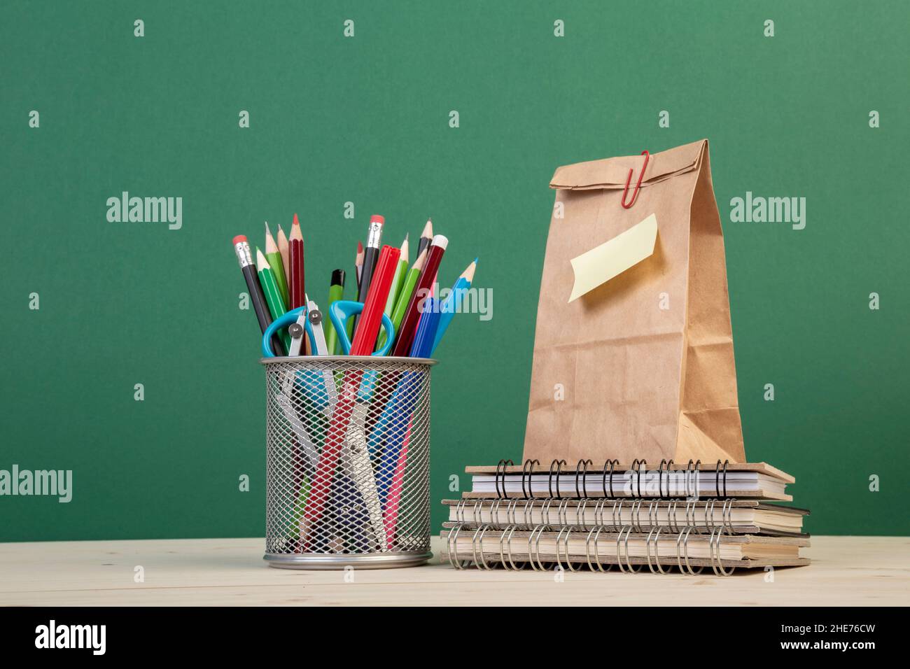 back to school template with stationeries and a paper lunch bag over green Stock Photo Alamy