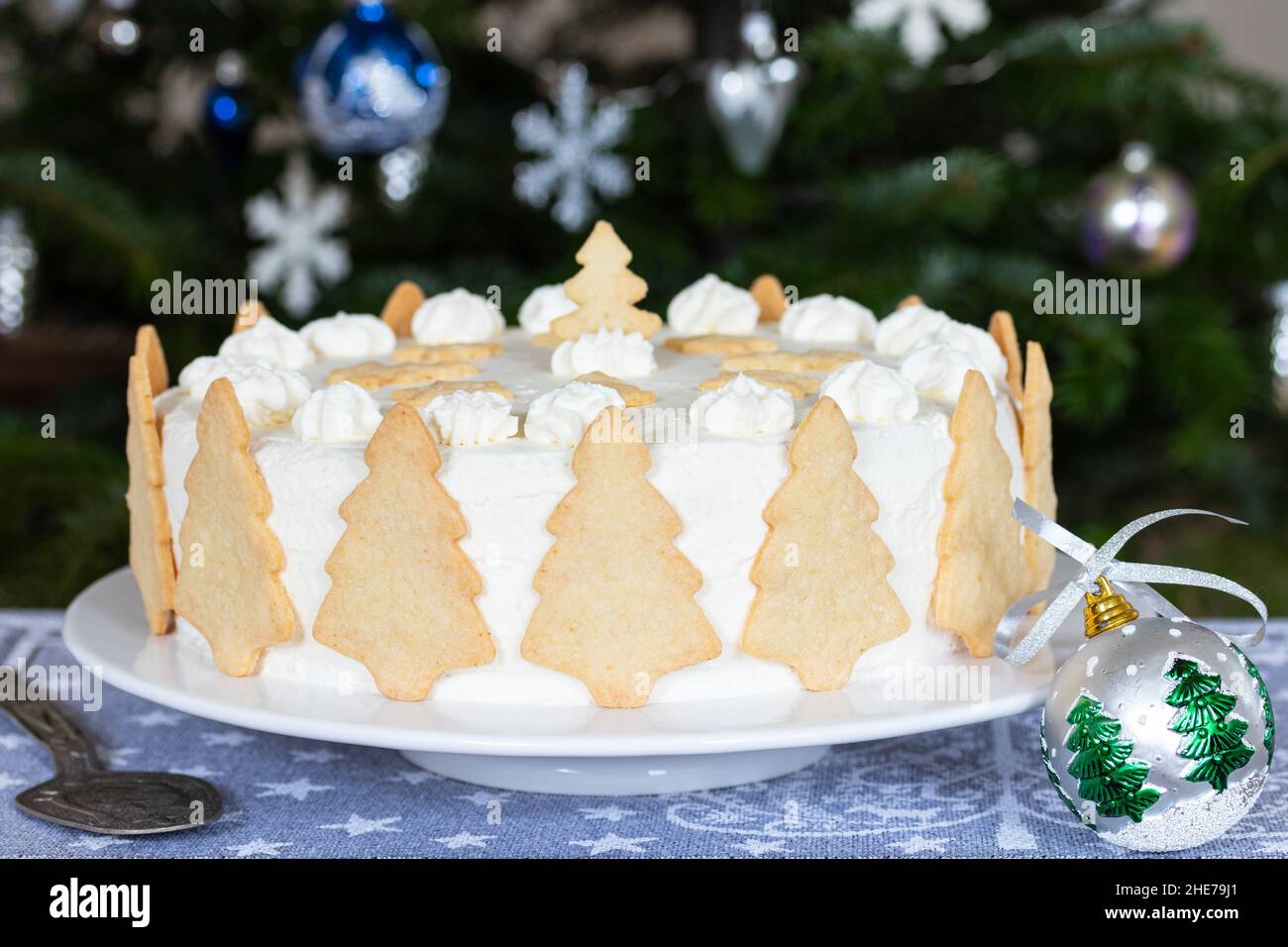 christmas cream cake with fir tree biscuits Stock Photo