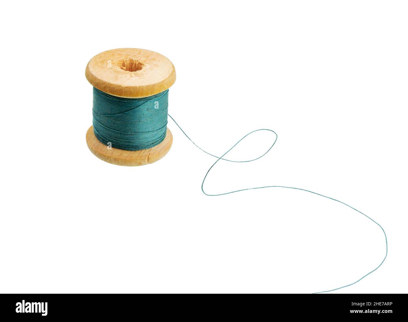 Sewing thread wooden spool of colors isolated on white. Wooden tube.  Old thread wooden spool. Stock Photo