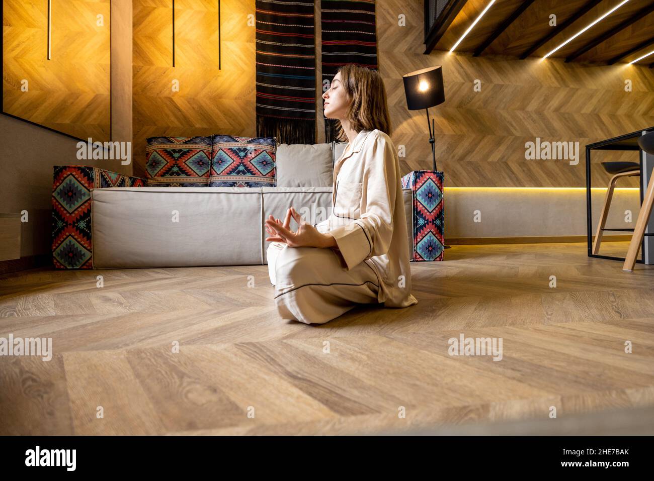 Woman feeling calm while meditating at home Stock Photo - Alamy