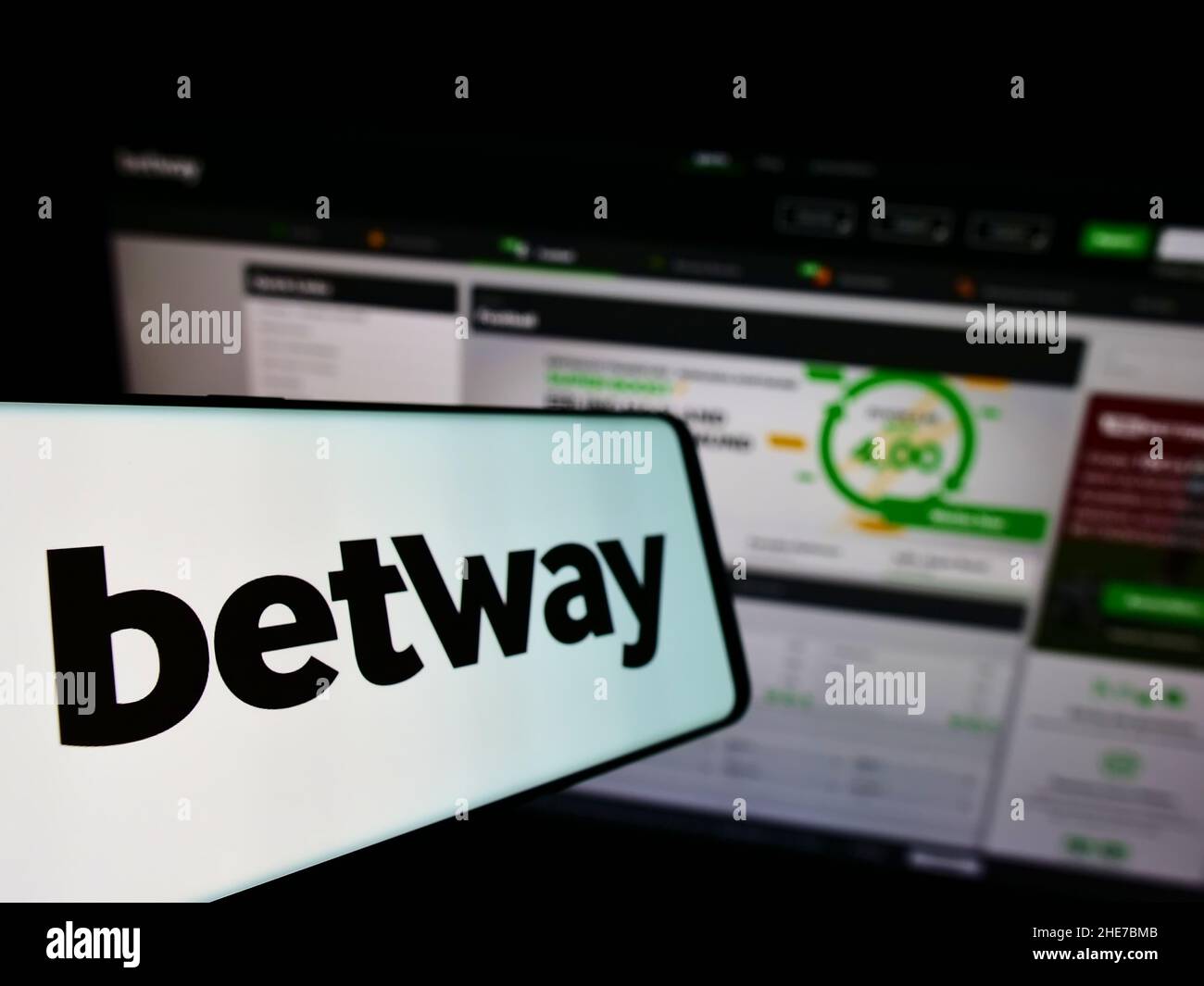 Smartphone with logo of sports betting company Betway Group on screen in front of business website. Focus on left of phone display. Stock Photo