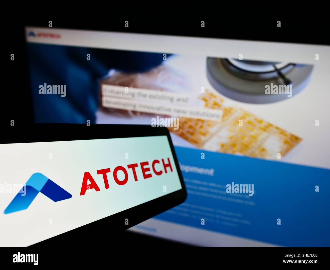 Smartphone with logo of chemical company Atotech Deutschland GmbH on screen in front of business website. Focus on center-left of phone display. Stock Photo