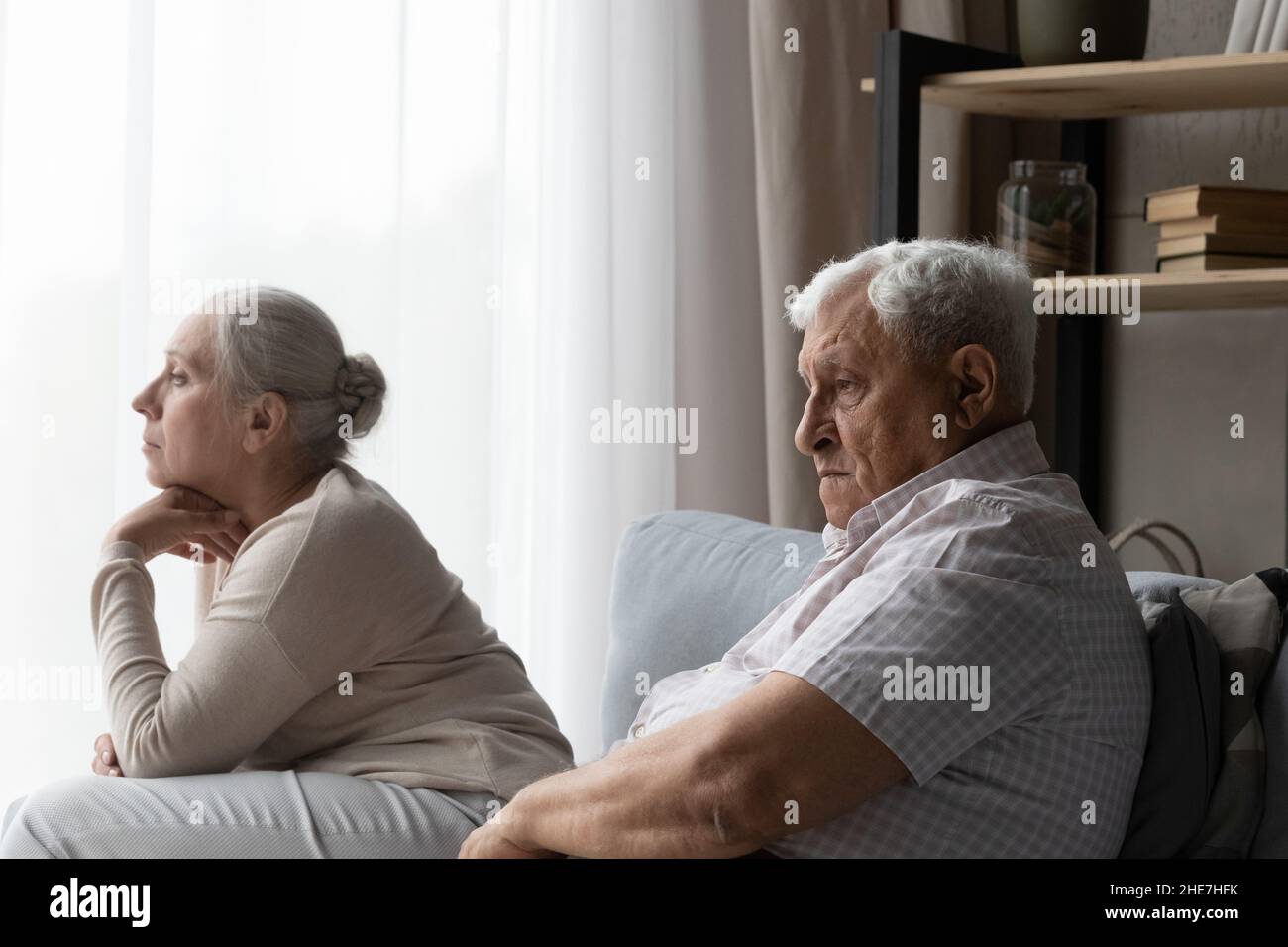 Frustrated unhappy old family couple feeling depressed at home. Stock Photo