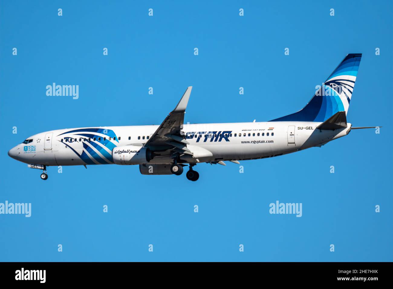 Madrid, Spain - December 31, 2021: Boeing 737-800 passenger aircraft of the airline Egyptair flying before landing against the clear blue sky. Stock Photo