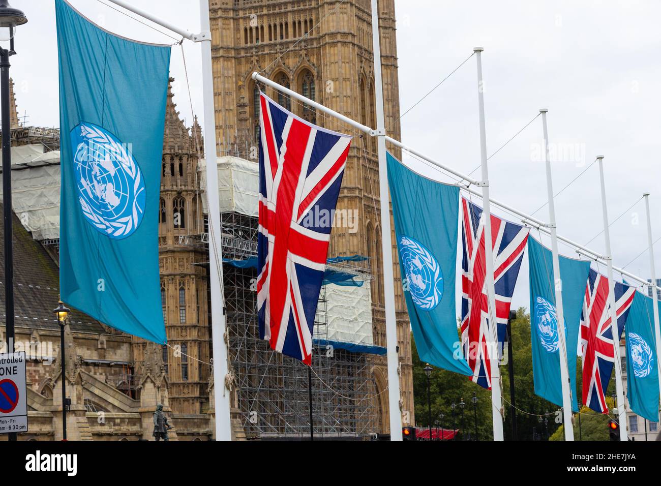 United nations and union jack flags on display outside houses of parliament, london, uk Stock Photo
