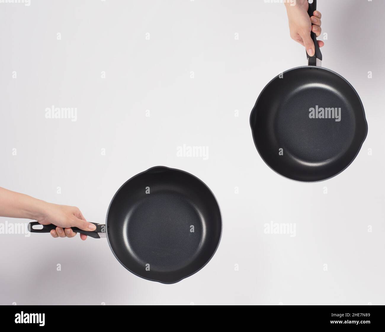 Cleaning Electric non stick pan. Hand on white background cleaning