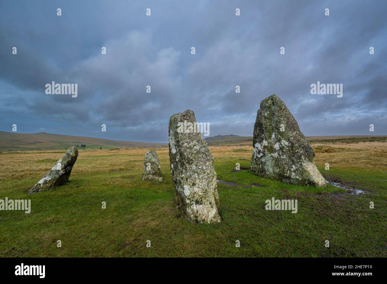 Merrivale, Dartmoor National Park. 9th January 2022. UK Weather: Dartmoor on a cloudy and wet Sunday afternoon. A view of a section of standing stones which form part of the megalithic stone rows at Merrivale with the rugged backdrop of Great Mis Tor seen in the distance. Credit: Celia McMahon/Alamy Live News Stock Photo