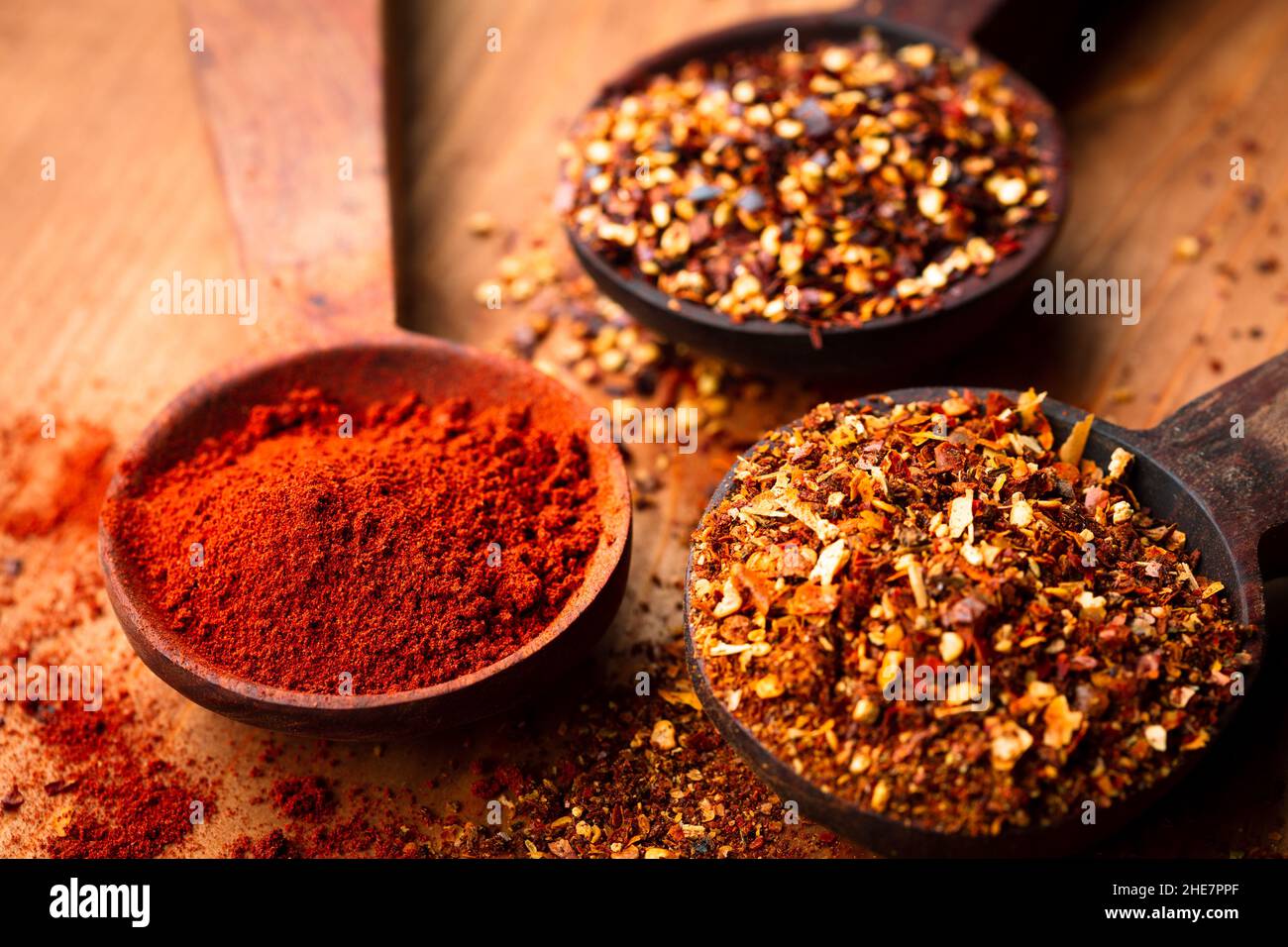 dried chili flakes and powder on wooden spoon Stock Photo Alamy