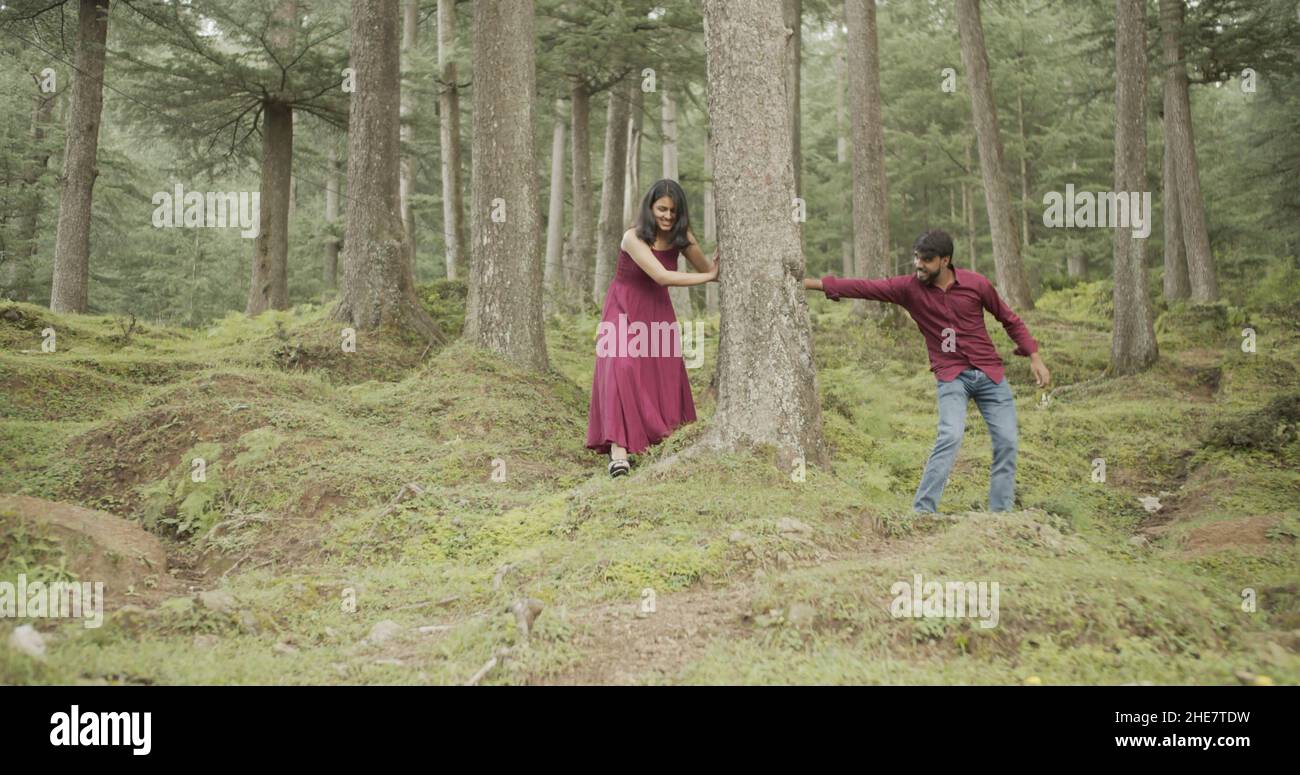 Young Indian couple having a fun while walking during a date at a park Stock Photo