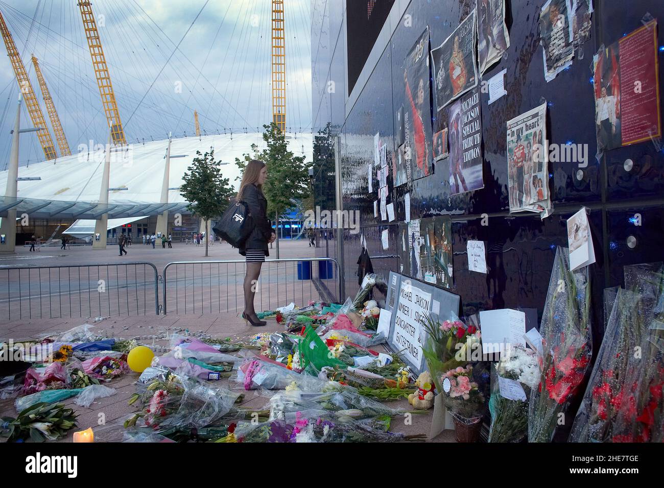 Michael Jackson fans stand at a shrine to the American singer, Tributes left at a shrine for Michael Jackson, outside the O2 Arena, London. Stock Photo