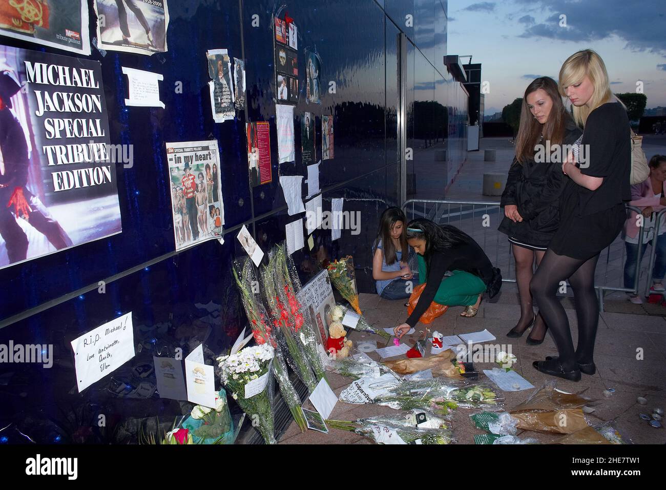 Michael Jackson fans stand at a shrine to the American singer, Tributes left at a shrine for Michael Jackson, outside the O2 Arena, London. Stock Photo