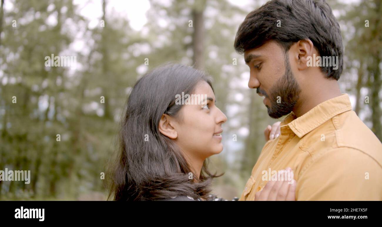 Young Indian couple looking deep into each other's eyes while having a ...