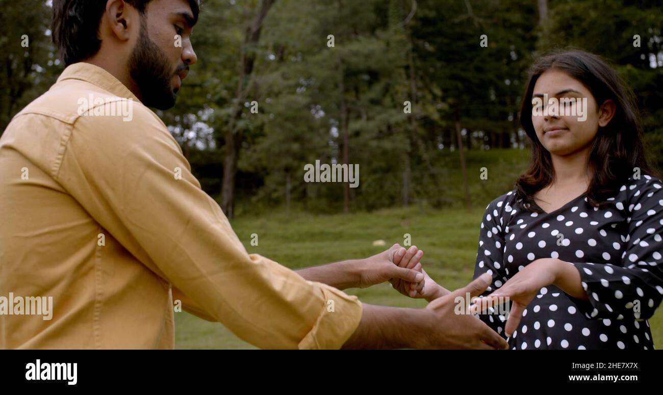 Young Indian couple holding hands at a park Stock Photo - Alamy