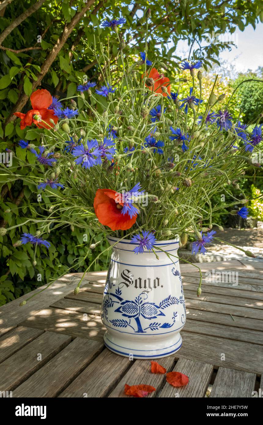 Bouquet of field flowers with cornflowers and poppies in an old vase, Bavaria, Germany Stock Photo