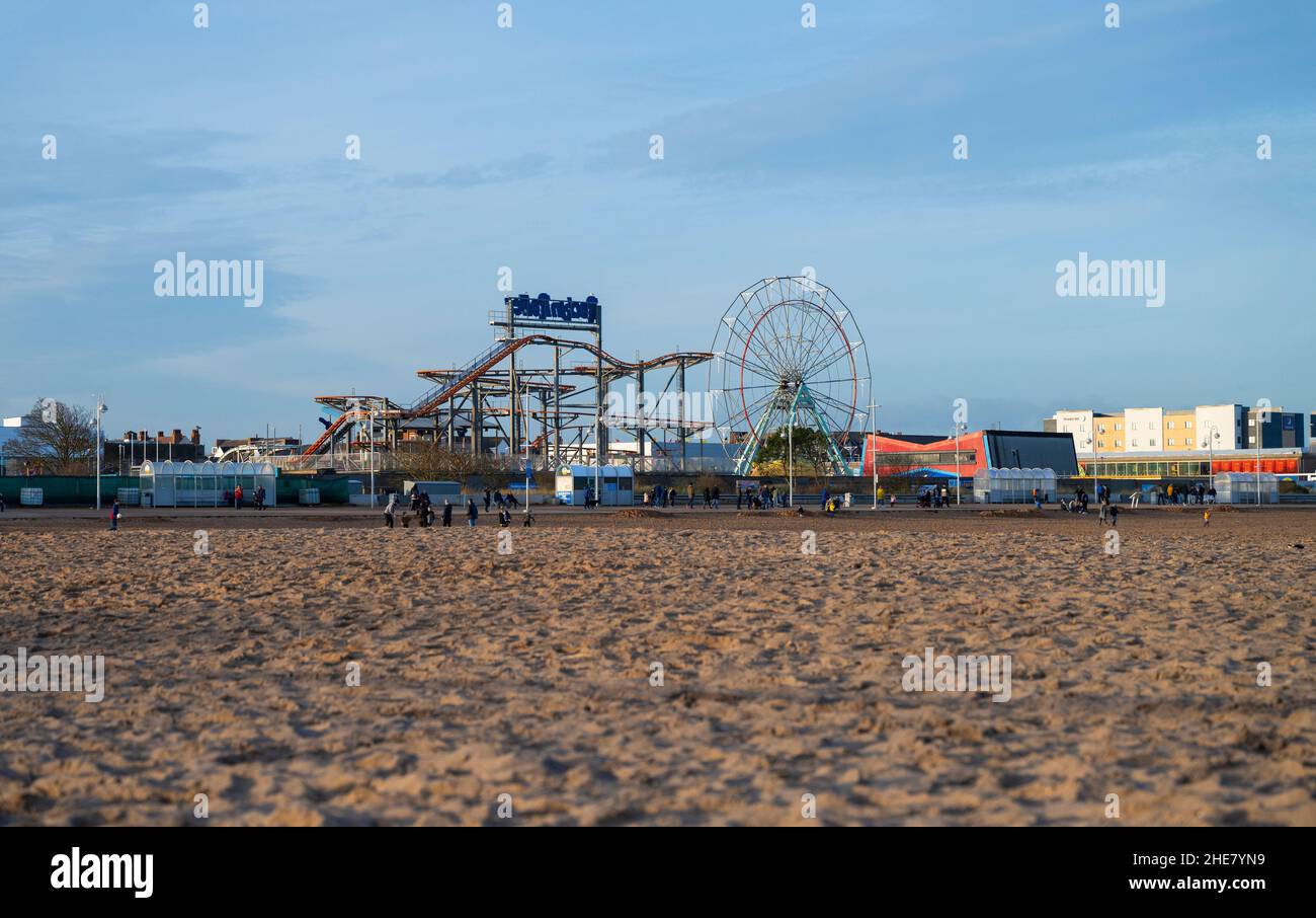 Funfair, rollercoaster and ferris wheel at Skegness, Lincolnshire, UK Stock Photo