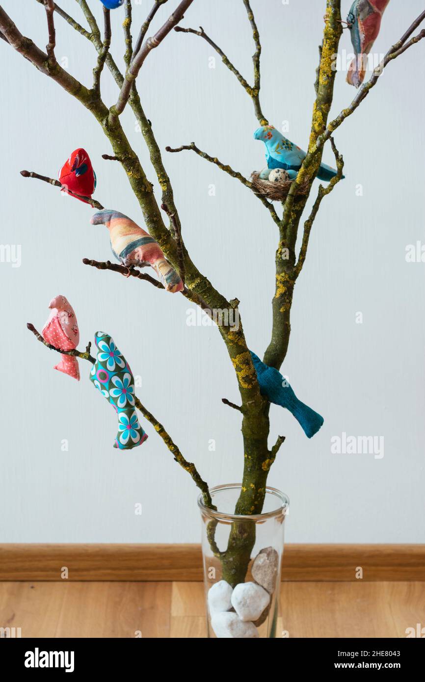 Hand made bird softies on branches. Stock Photo