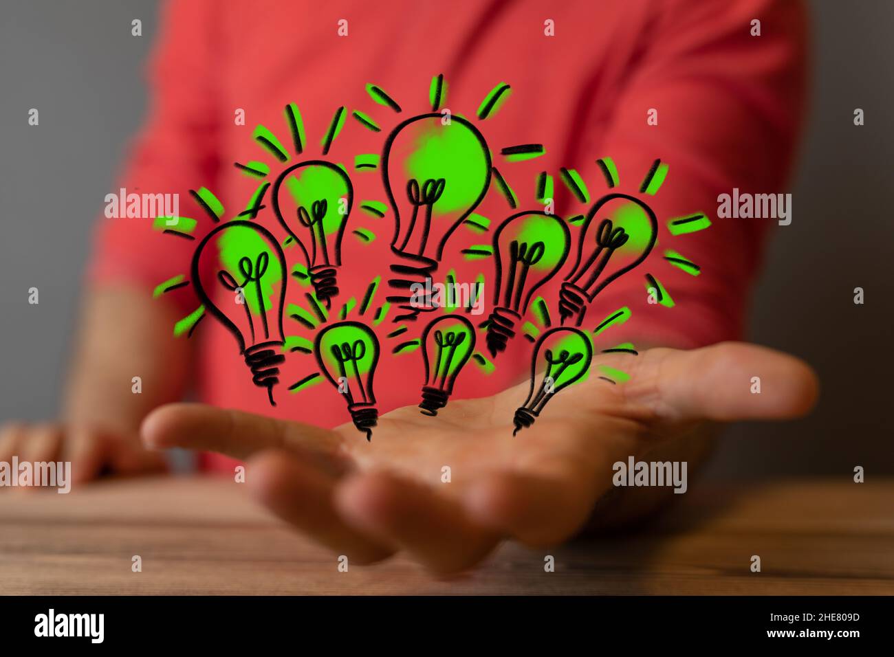 Male blurred hand holding a digital Light Bulb lamp saving energy ...