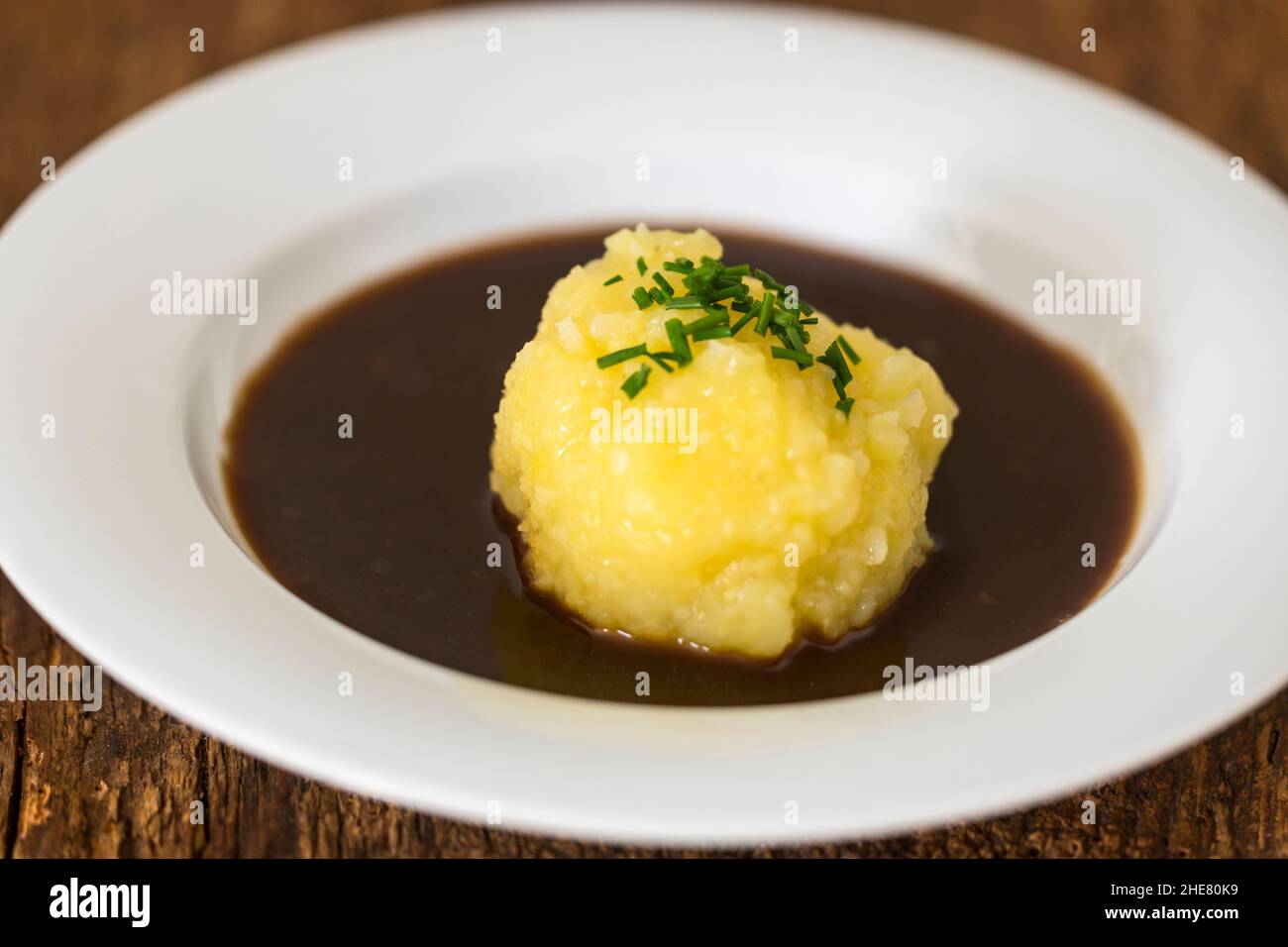 bavarian dumpling in a plate with sauce Stock Photo