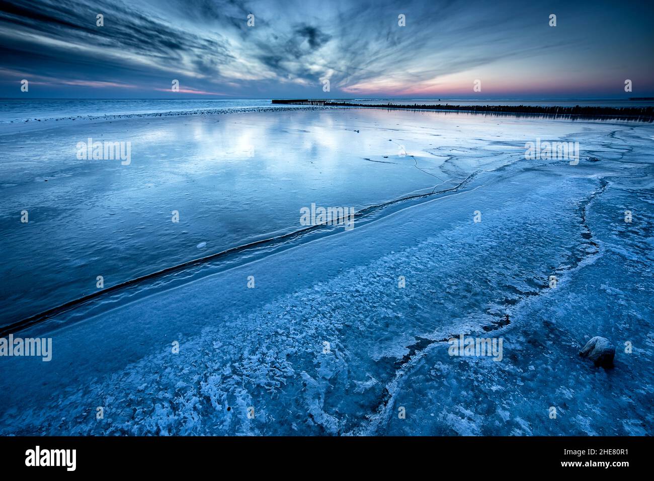 frozen big lake in dusk, Ijsselmeer, Netherlands Stock Photo