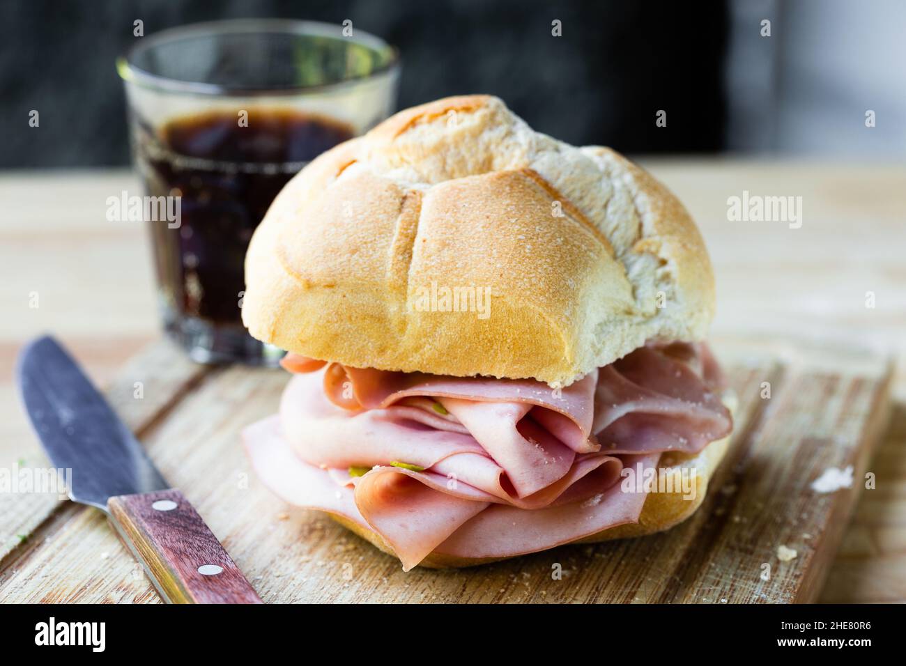 mortadella sandwich on cutting board closeup Stock Photo