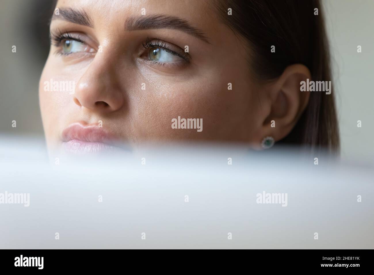 Thoughtful young business woman using laptop computer Stock Photo