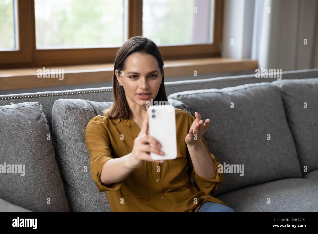 Beautiful millennial telephone caller woman talking on mobile phone ...