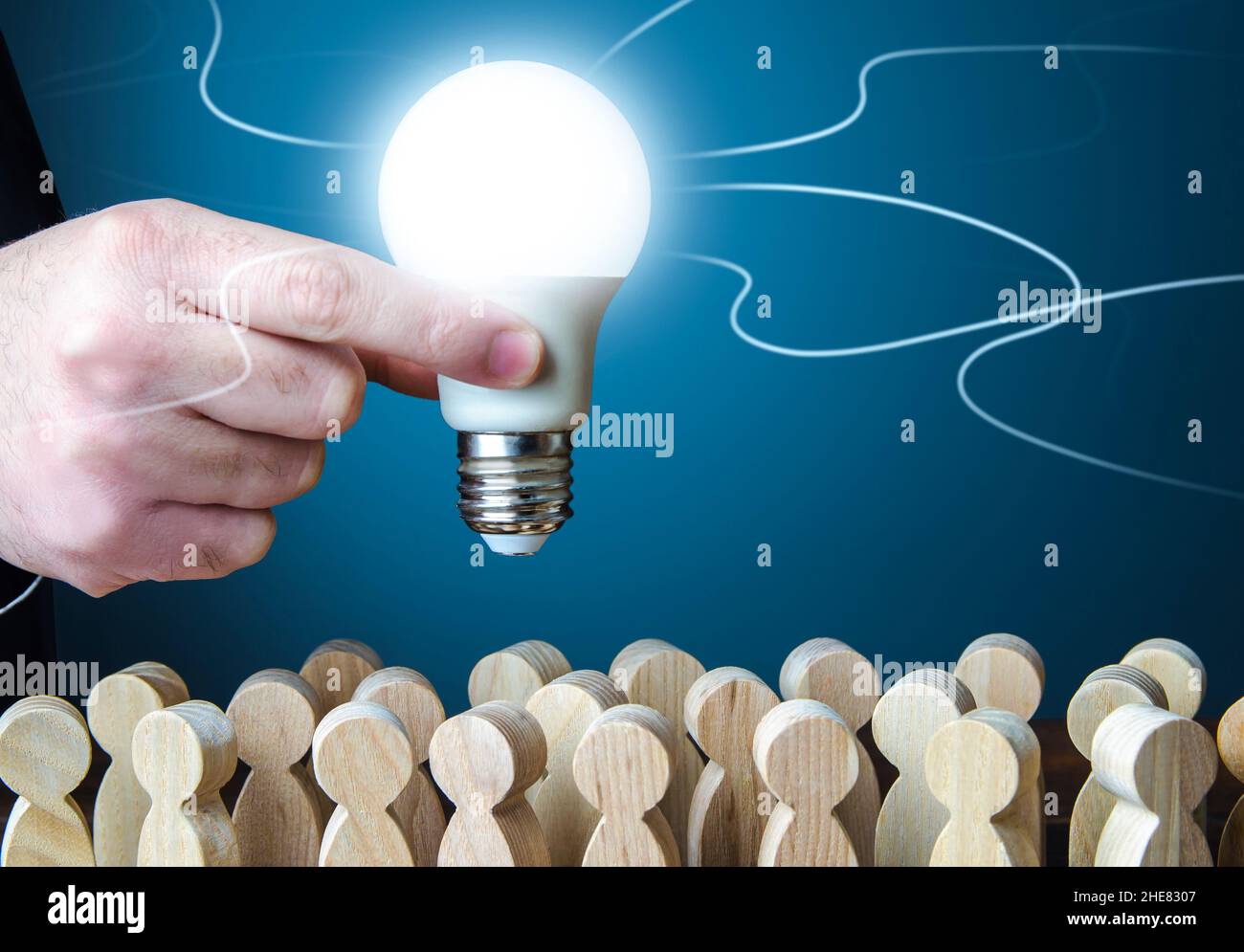A man holds an idea light bulb above the crowd. Project leader. Teamwork. Brainstorming. Creativity. Informant. Statistics, survey. Research and devel Stock Photo