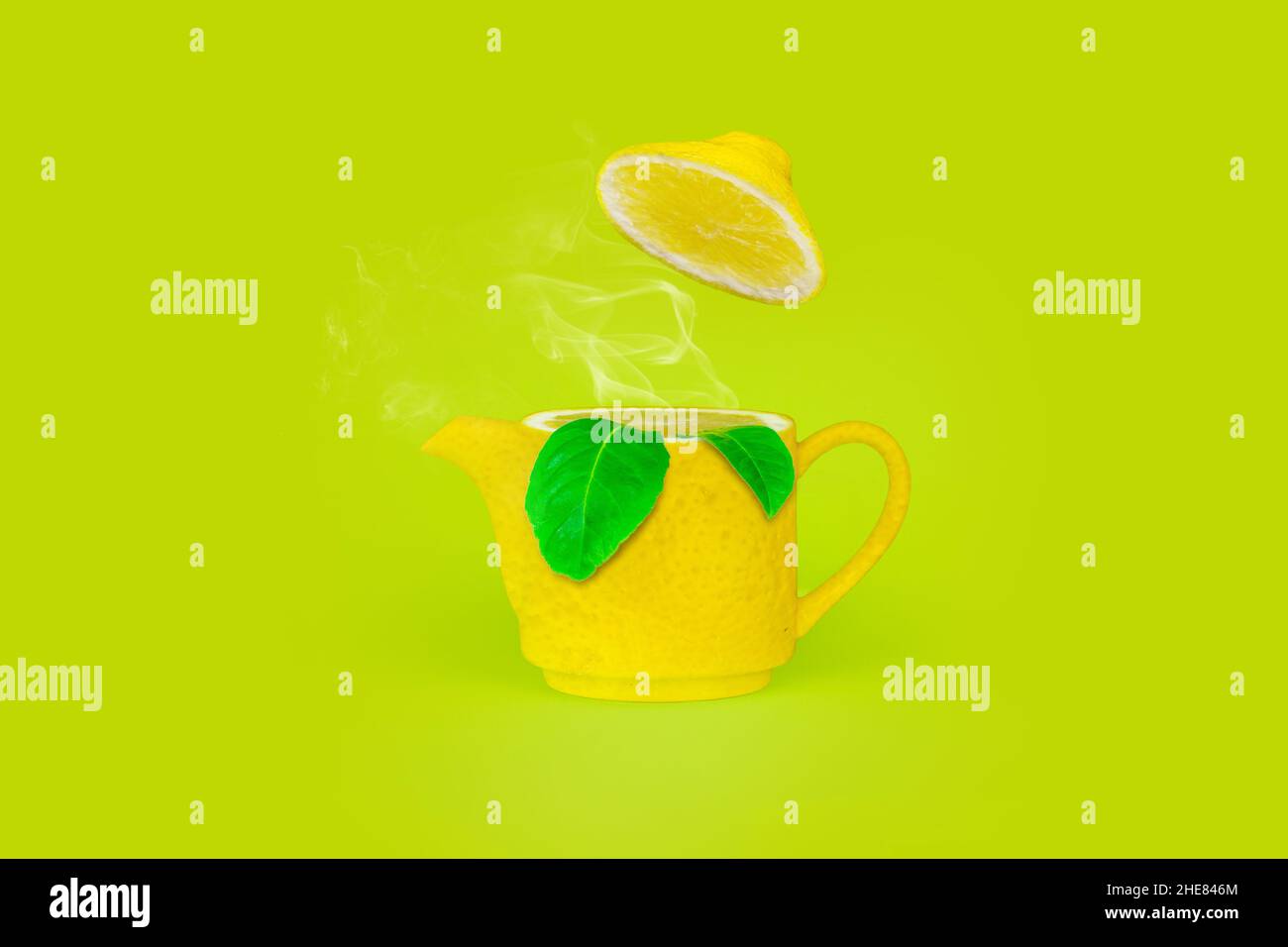 Lemon kettle teapot with steam and leaf on light green background