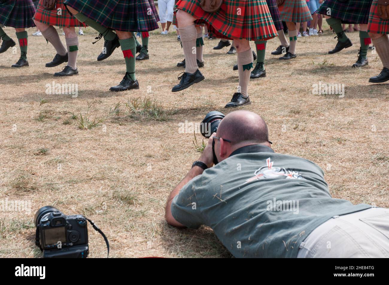 Photographer gets a low angle shot of marching bagpiper's legs  and kilt hems. Stock Photo