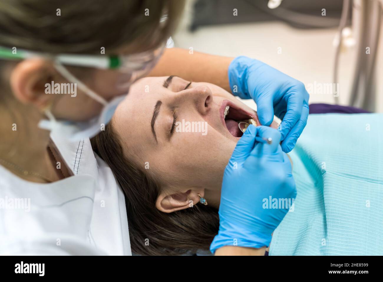 Dentist checking patient's teeth with mirror in dentistry Stock Photo