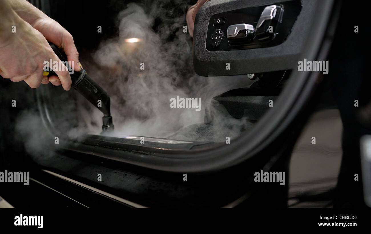 Detailing the car. Cleaning the car interior with steam. Car detailing