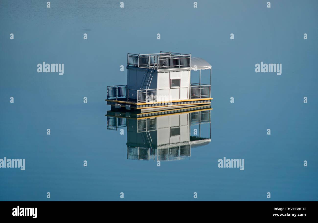 Close up shot of a floating House alone in the middle of the water Stock Photo