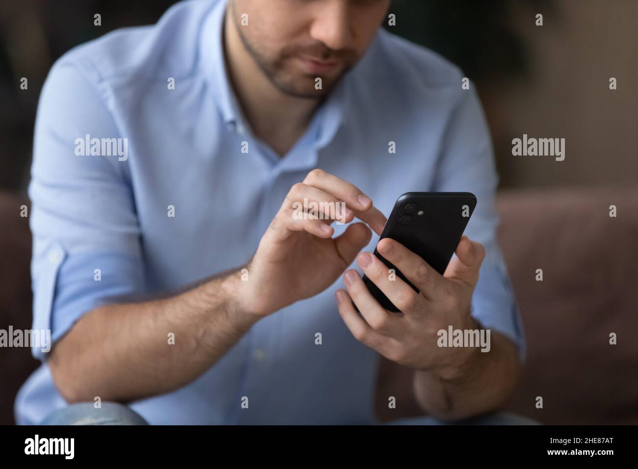Cropped close up man using smartphone, typing on screen Stock Photo
