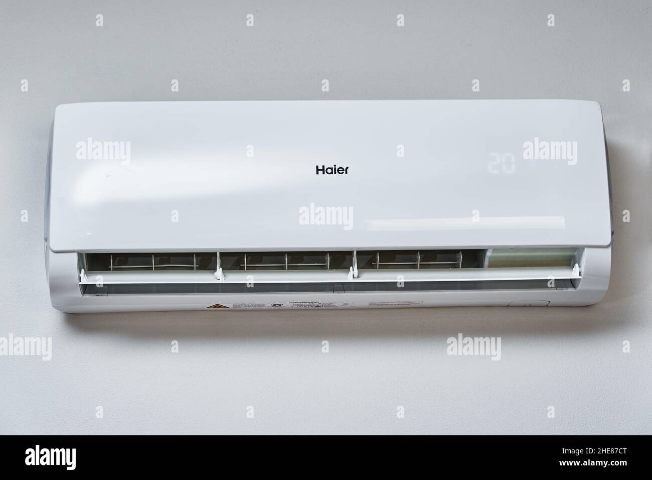 Adjusting temperature on air conditioner, Working air conditioner for comfort temperature in home at hot summer, cooling air in the room Stock Photo