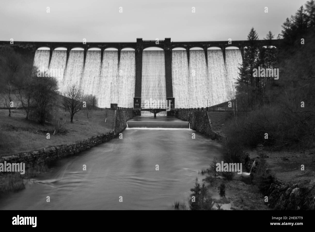 After heavy rain in Wales torrents of water cascade over Claerwen Dam in the Elan Valley Powys UK. December 2021. Stock Photo