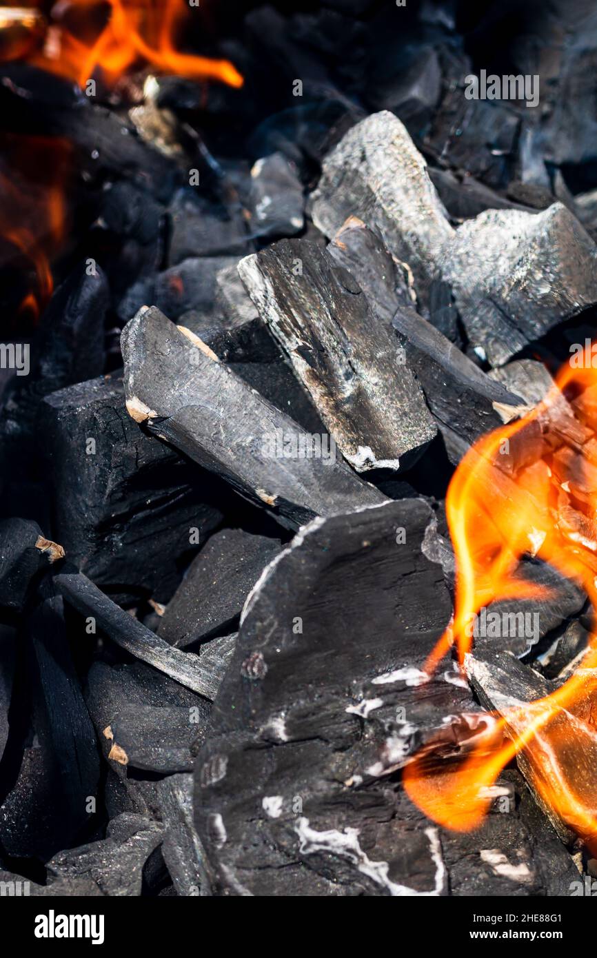 Barbecue grill pit with glowing and flaming hot open fire with red