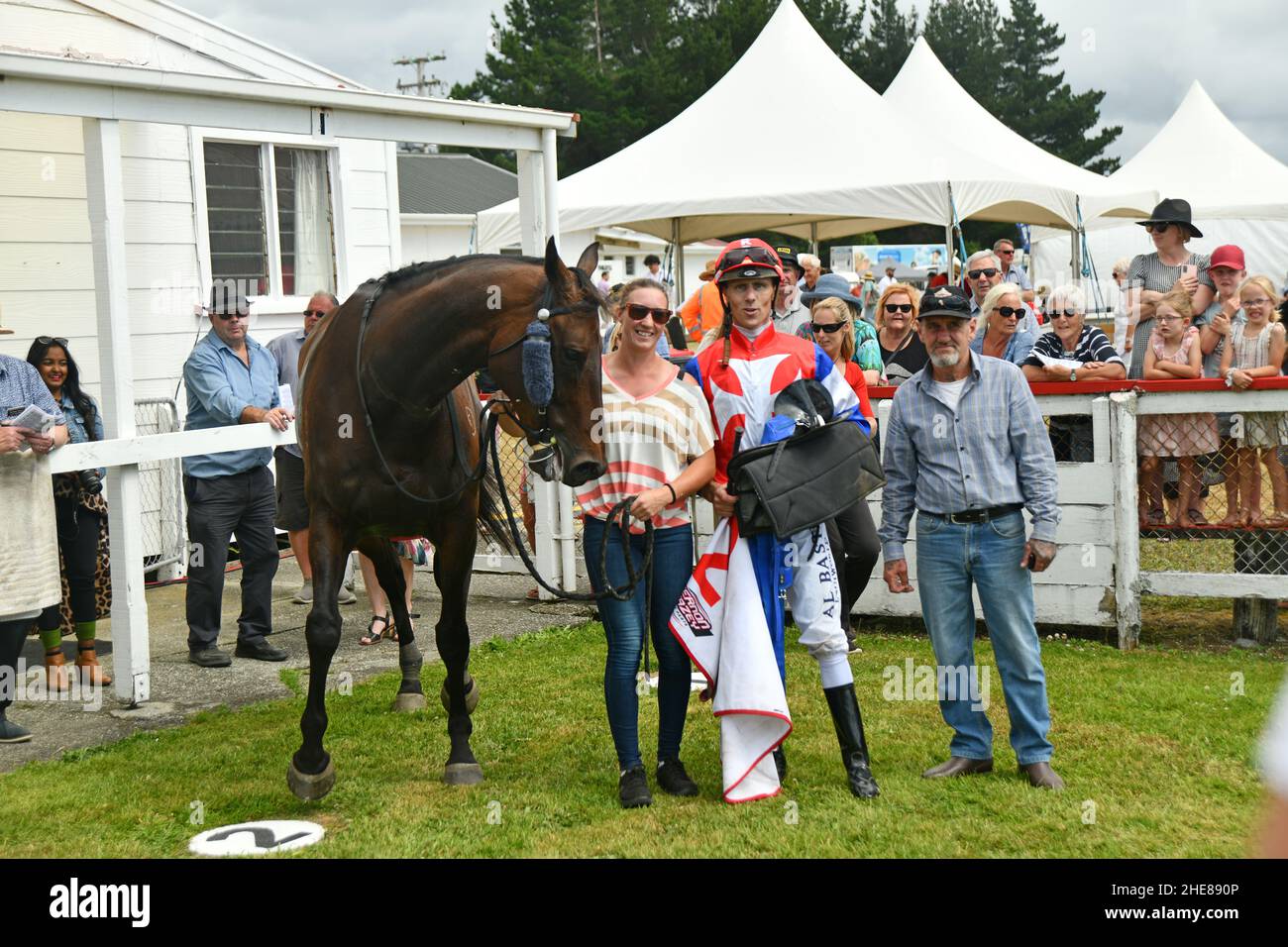 KUMARA, NEW ZEALAND, JANUARY 8, 2022; The winning thoroughbred of the Gold Nuggets trophy, Camino Rocoso in the winners circle with trainer, jockey and owner at the Kumara Race Track on , January 8, 2022 . Stock Photo