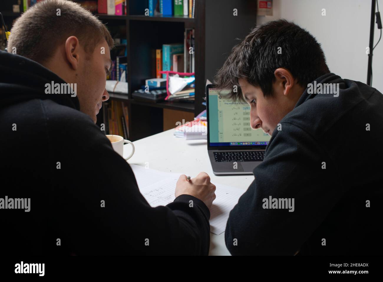 Private maths tutoring. Student hepls high school pupil,UK Stock Photo
