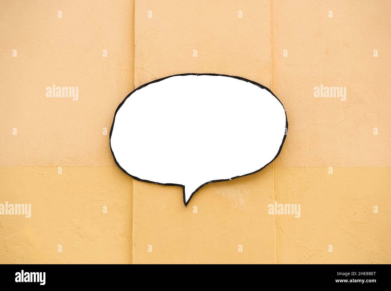 Top view of speech balloon bubble sign copy space on light orange background Stock Photo