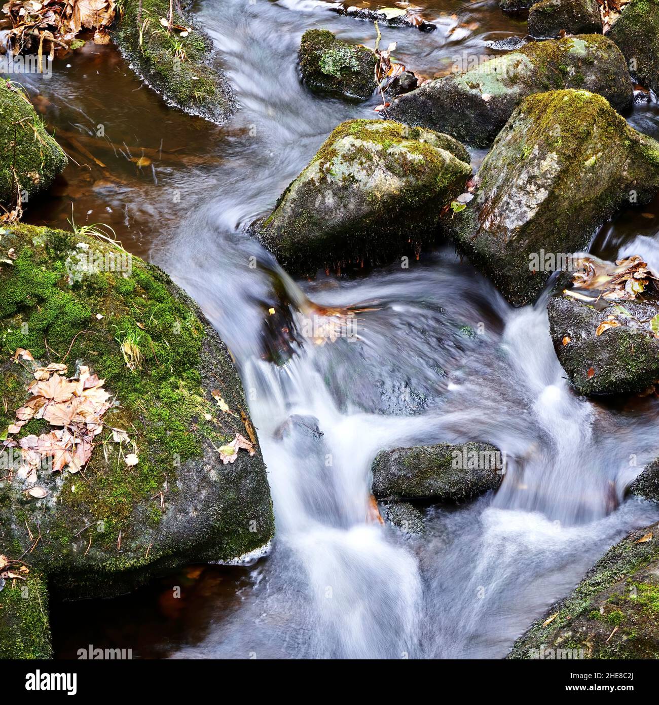 Stream flowing into rocks hi-res stock photography and images - Alamy