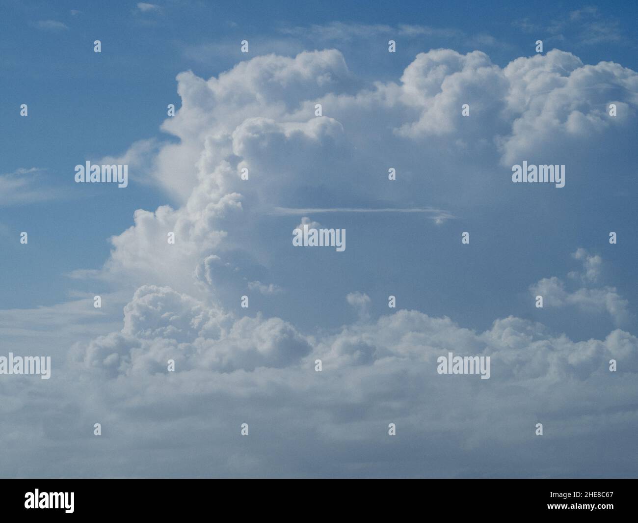 Heavenly puffy white Cumulus clouds floating along in a blue sky ...